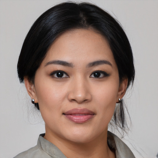 Joyful asian young-adult female with medium  black hair and brown eyes