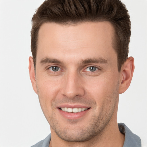 Joyful white young-adult male with short  brown hair and brown eyes