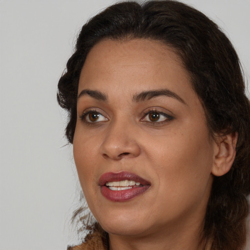 Joyful black adult female with medium  brown hair and brown eyes