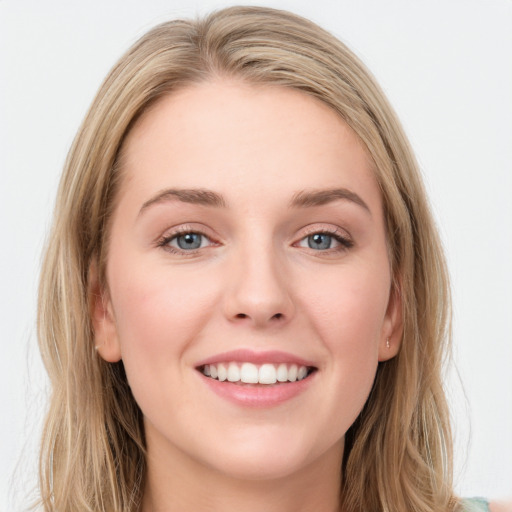 Joyful white young-adult female with long  brown hair and blue eyes