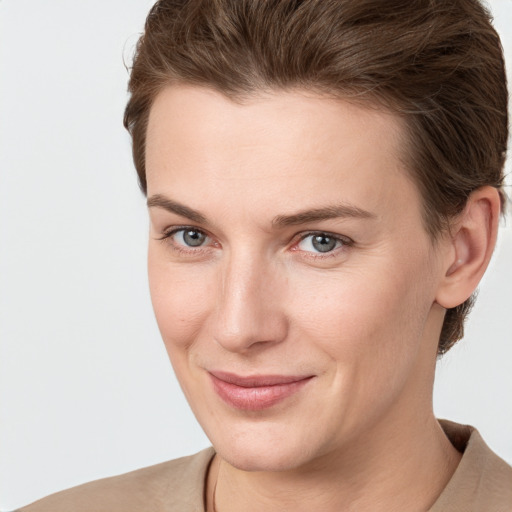 Joyful white young-adult female with short  brown hair and grey eyes