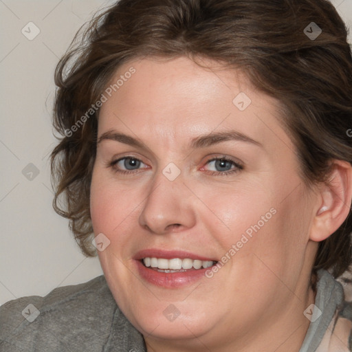 Joyful white adult female with medium  brown hair and blue eyes