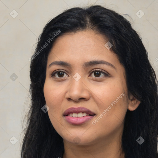 Joyful latino young-adult female with long  black hair and brown eyes