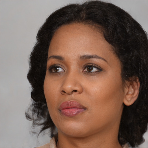 Joyful black young-adult female with medium  brown hair and brown eyes