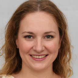 Joyful white young-adult female with medium  brown hair and green eyes