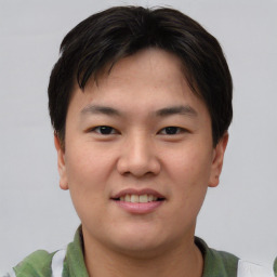 Joyful asian young-adult male with short  brown hair and brown eyes