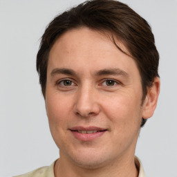 Joyful white adult male with short  brown hair and grey eyes