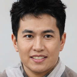 Joyful asian young-adult male with short  brown hair and brown eyes