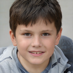 Joyful white child male with short  brown hair and brown eyes