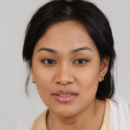 Joyful asian young-adult female with medium  brown hair and brown eyes