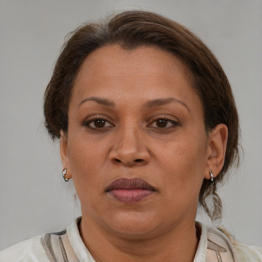 Joyful white adult female with medium  brown hair and brown eyes