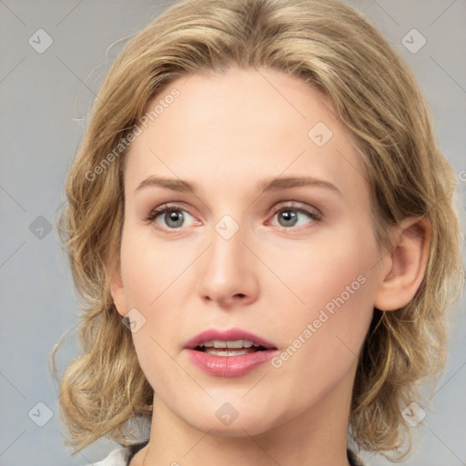 Joyful white young-adult female with medium  brown hair and blue eyes