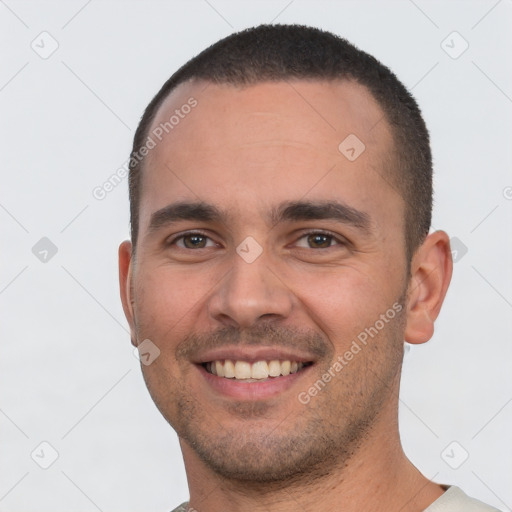 Joyful white young-adult male with short  black hair and brown eyes