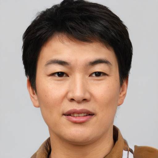Joyful asian young-adult female with short  brown hair and brown eyes