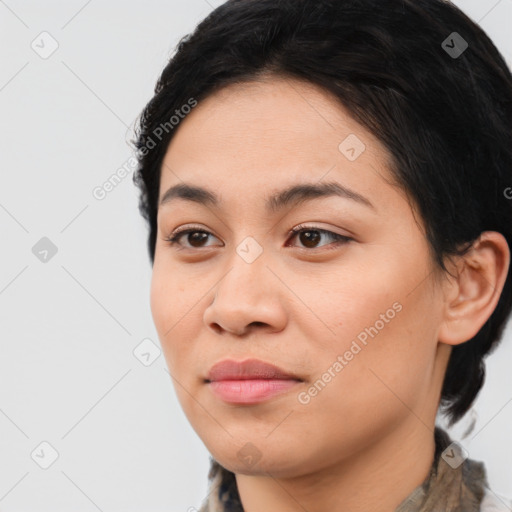 Joyful latino young-adult female with medium  brown hair and brown eyes