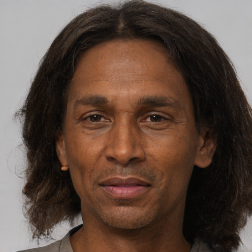 Joyful white adult male with medium  brown hair and brown eyes