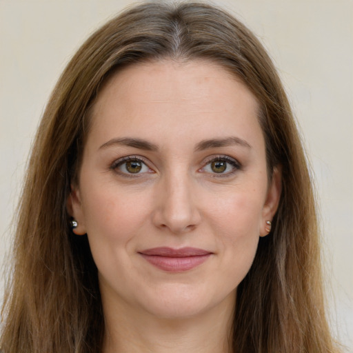 Joyful white young-adult female with long  brown hair and green eyes