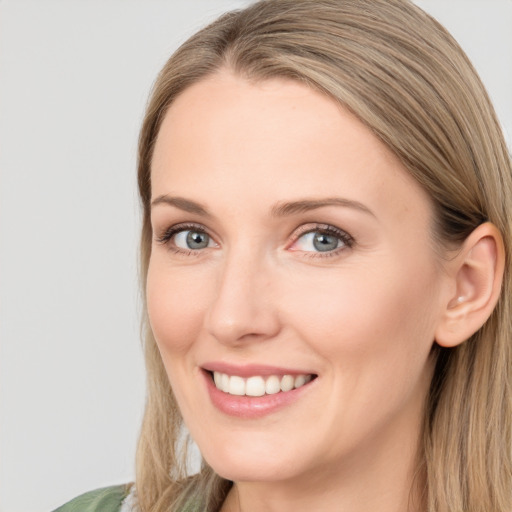 Joyful white young-adult female with long  brown hair and green eyes