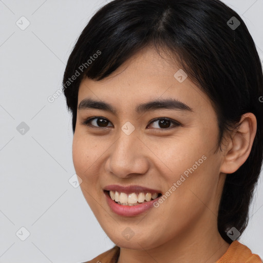 Joyful asian young-adult female with medium  brown hair and brown eyes