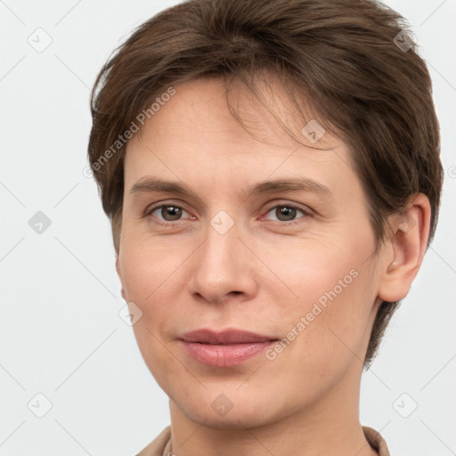 Joyful white young-adult female with short  brown hair and grey eyes