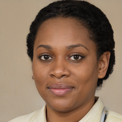 Joyful black young-adult female with short  brown hair and brown eyes