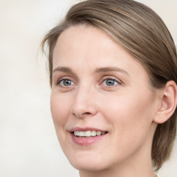 Joyful white young-adult female with medium  brown hair and blue eyes