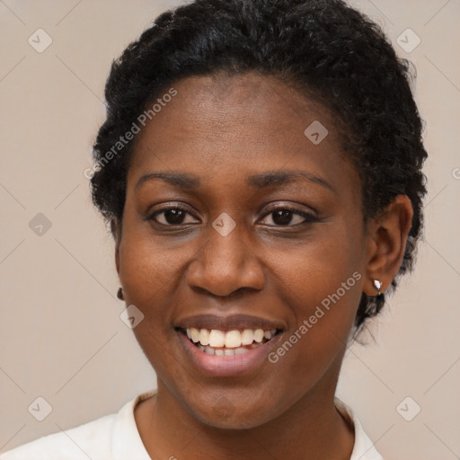 Joyful black young-adult female with short  black hair and brown eyes