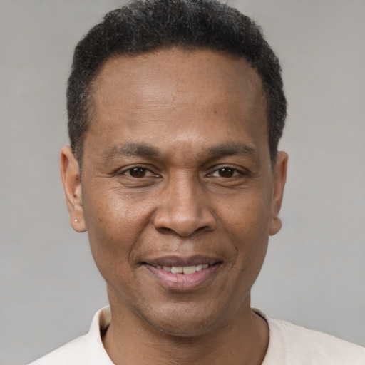 Joyful latino adult male with short  brown hair and brown eyes
