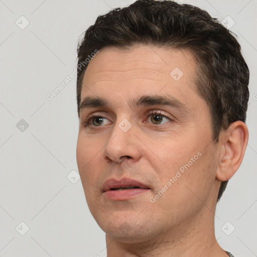 Joyful white adult male with short  brown hair and brown eyes