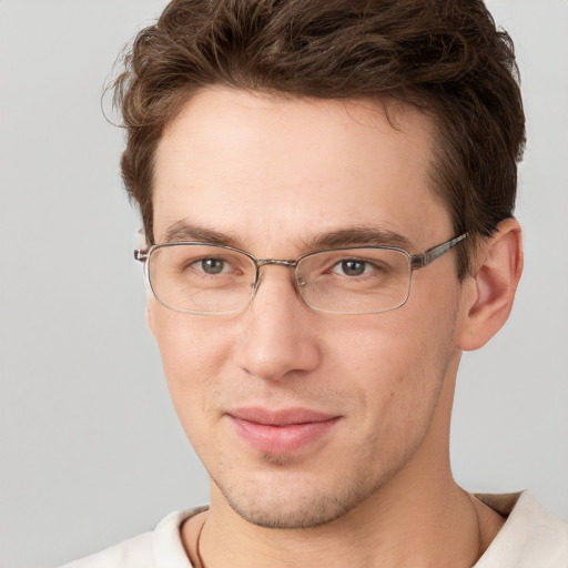 Joyful white adult male with short  brown hair and grey eyes