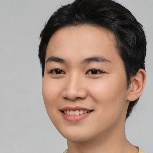 Joyful asian young-adult female with short  black hair and brown eyes