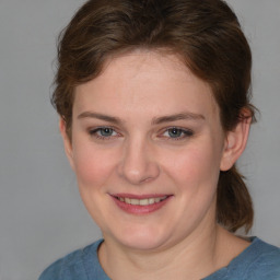 Joyful white young-adult female with medium  brown hair and blue eyes