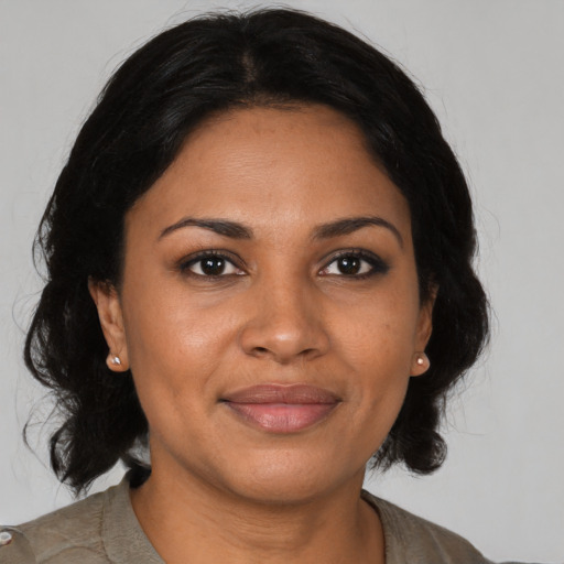 Joyful black young-adult female with medium  brown hair and brown eyes
