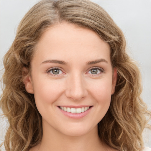 Joyful white young-adult female with long  brown hair and blue eyes