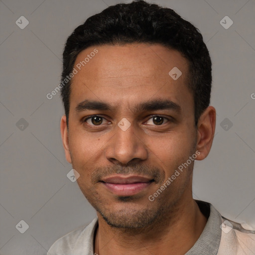 Joyful latino young-adult male with short  black hair and brown eyes