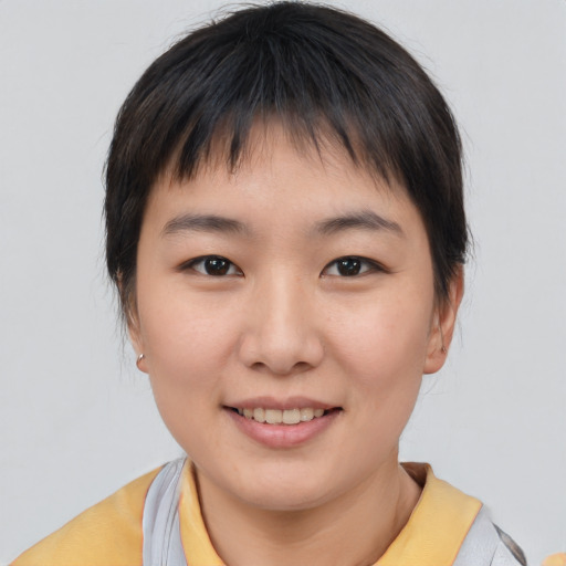 Joyful asian young-adult female with short  brown hair and brown eyes
