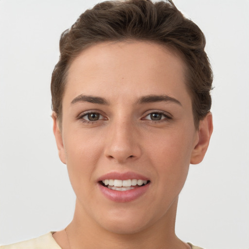 Joyful white young-adult female with short  brown hair and brown eyes