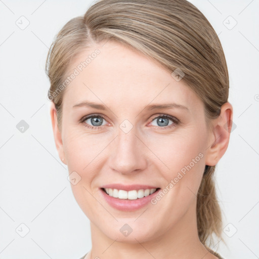 Joyful white young-adult female with medium  brown hair and blue eyes