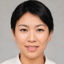 Joyful asian young-adult female with short  brown hair and brown eyes