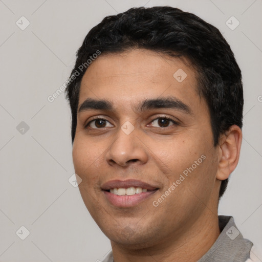 Joyful white young-adult male with short  black hair and brown eyes