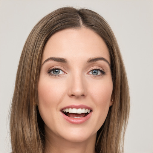 Joyful white young-adult female with long  brown hair and green eyes