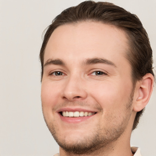 Joyful white young-adult male with short  brown hair and brown eyes