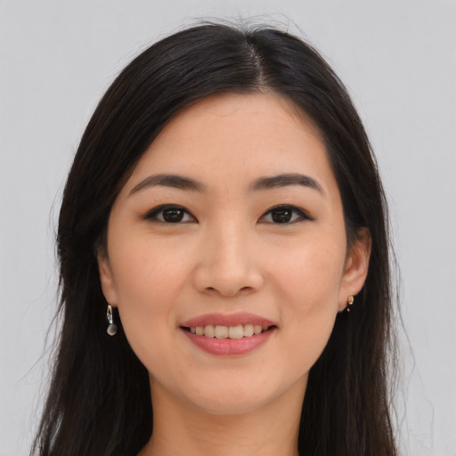 Joyful asian young-adult female with long  brown hair and brown eyes