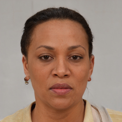 Joyful latino adult female with short  brown hair and brown eyes