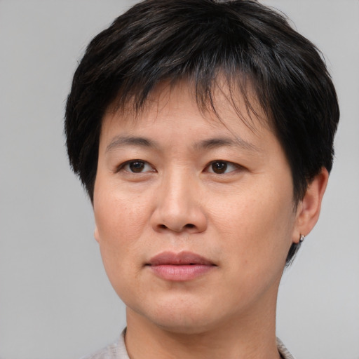 Joyful asian young-adult female with short  brown hair and brown eyes