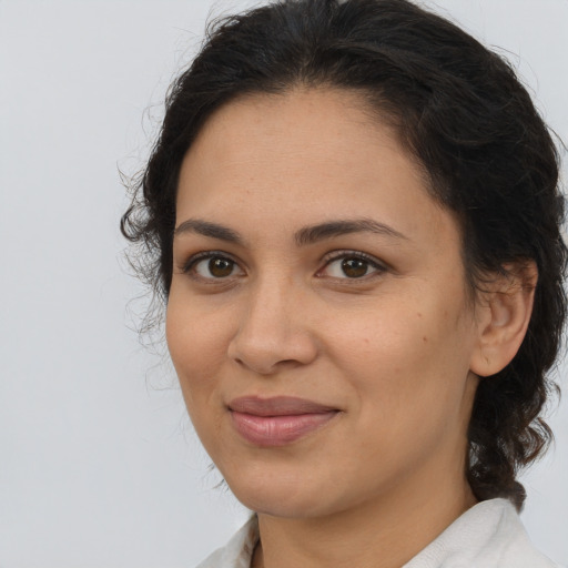 Joyful latino young-adult female with medium  brown hair and brown eyes