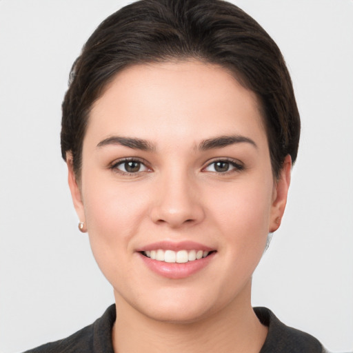 Joyful white young-adult female with short  brown hair and brown eyes