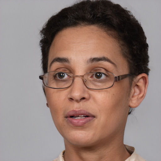 Joyful black adult female with short  brown hair and brown eyes