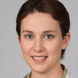 Joyful white young-adult female with medium  brown hair and grey eyes