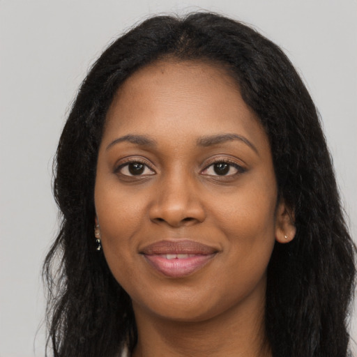 Joyful latino young-adult female with long  black hair and brown eyes